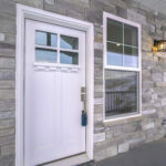 White wooden front door with sash windows